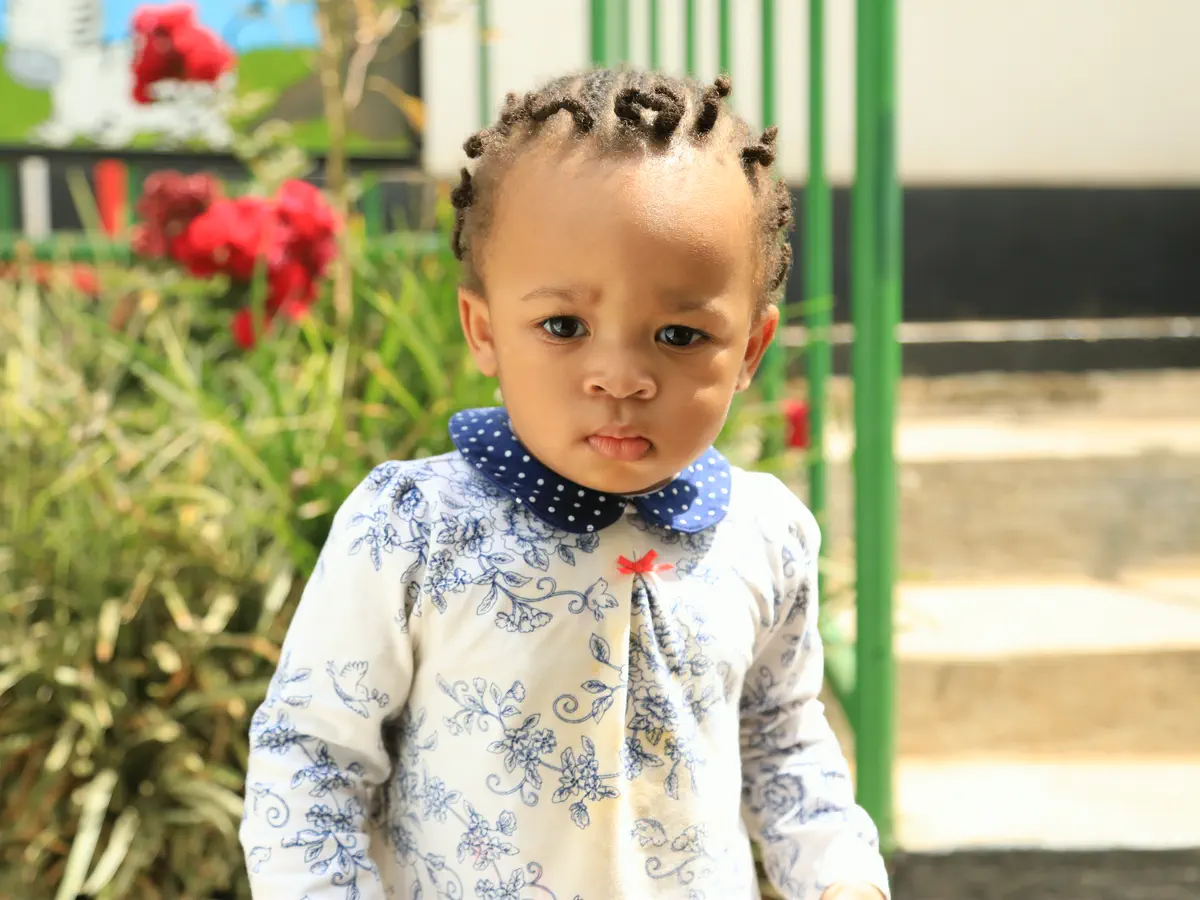 A toddler in the school garden